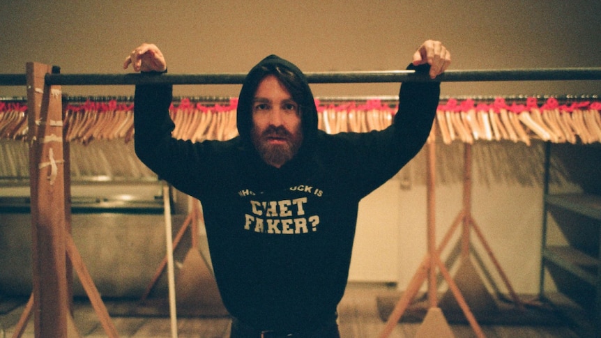 Press shot of Chet Faker, wearing hoodie with his own name