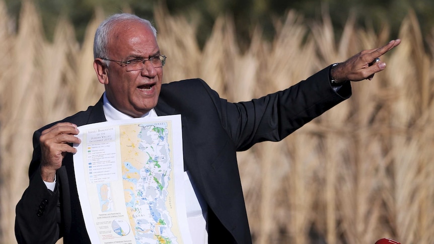 Palestinian Chief negotiator Saeb Erekat holds a map as he speaks about the Israeli plan to appropriate land.