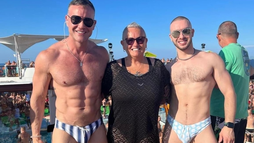 William, Sheryll, and another party-goer standing outside on a gay cruise.