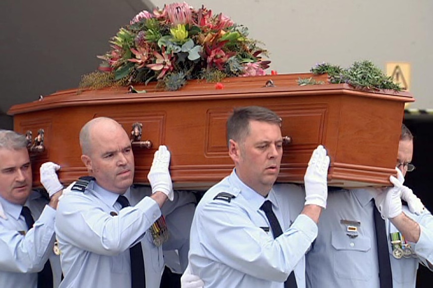 Servicemen carry the coffin of Robert Cowper.