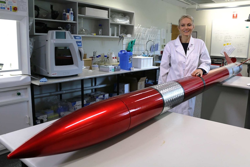 Samantha Ridgway in a laboratory with a large red rocket