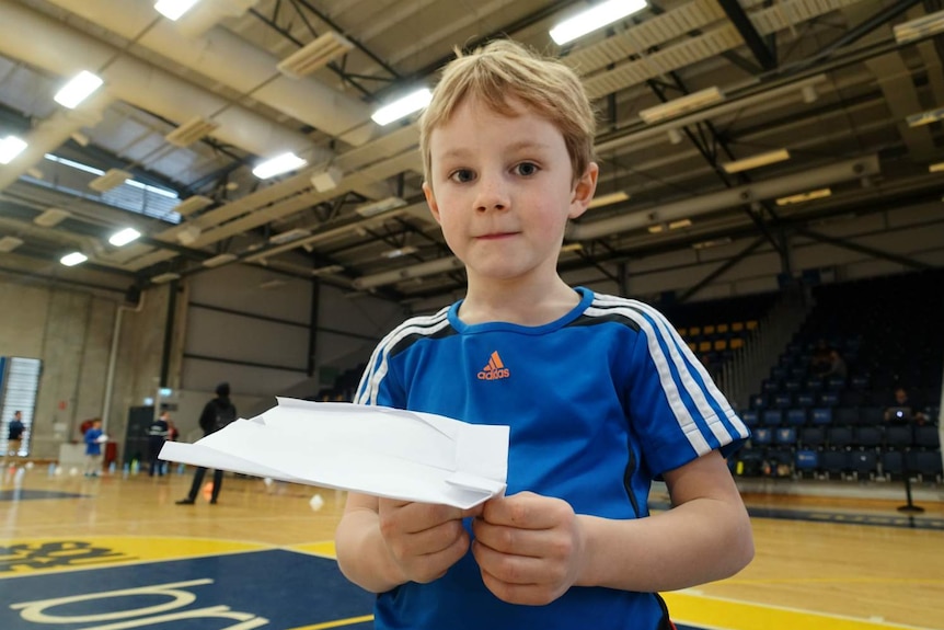 A boy looks at the camera.