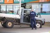 The ute at a Yass service station with the front wheels torn up.