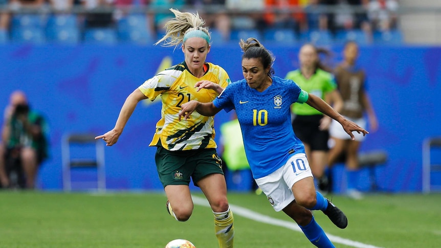 Marta dribbles the ball as Ellie Carpenter challenges her.