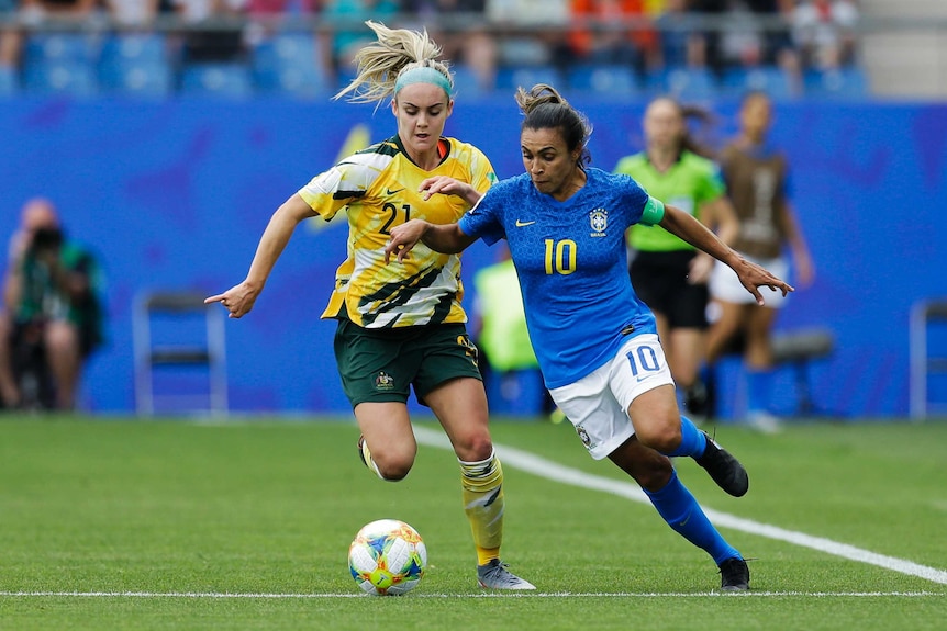 Marta dribbles the ball as Ellie Carpenter challenges her.