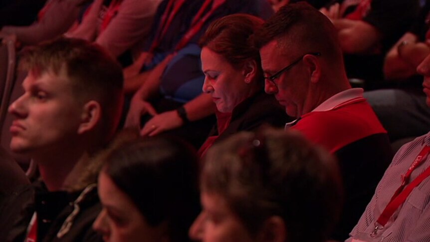 Deputy Queensland Premier Jackie Trad sits with her head down in the audience