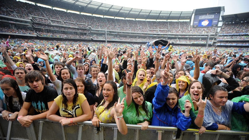 Fans enjoy themselves in the rain at Sound Relief.