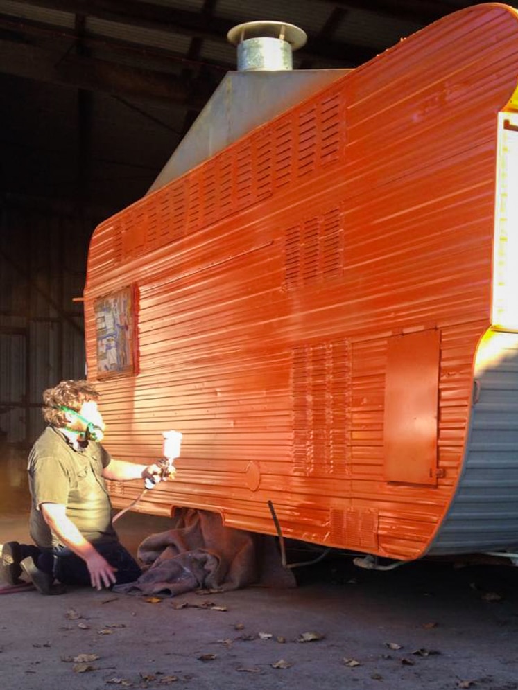 Tristan Abbott painted the white caravan bright orange.