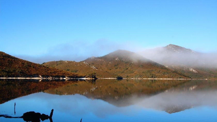 A thin veil of mist hangs over Lake Pedder