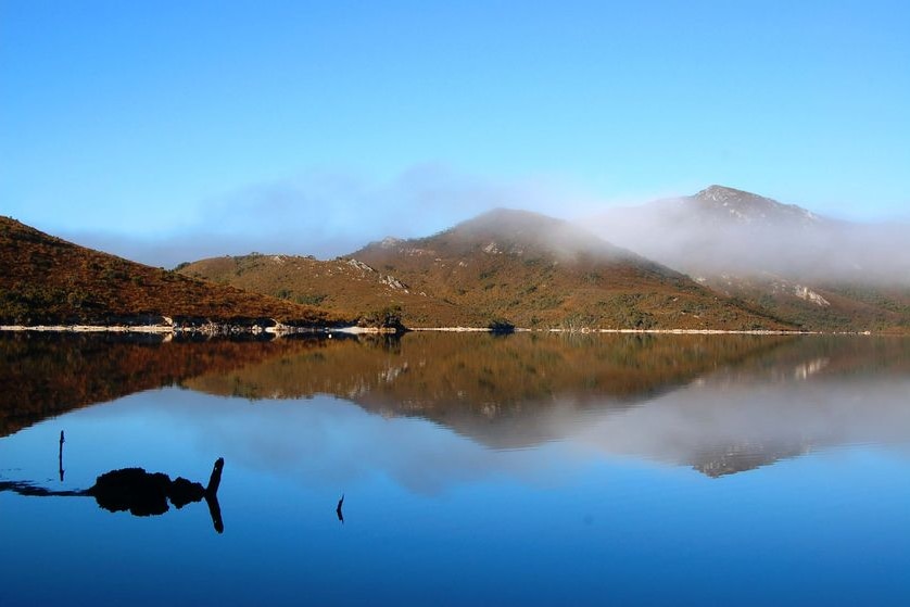 A thin veil of mist hangs over Lake Pedder