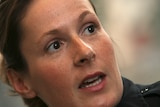 A very close up face shot shows Officer Kim Potter speaking.