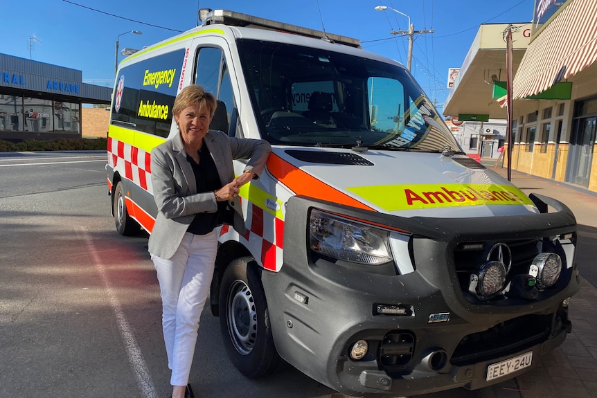 woman standing next to ambulance 