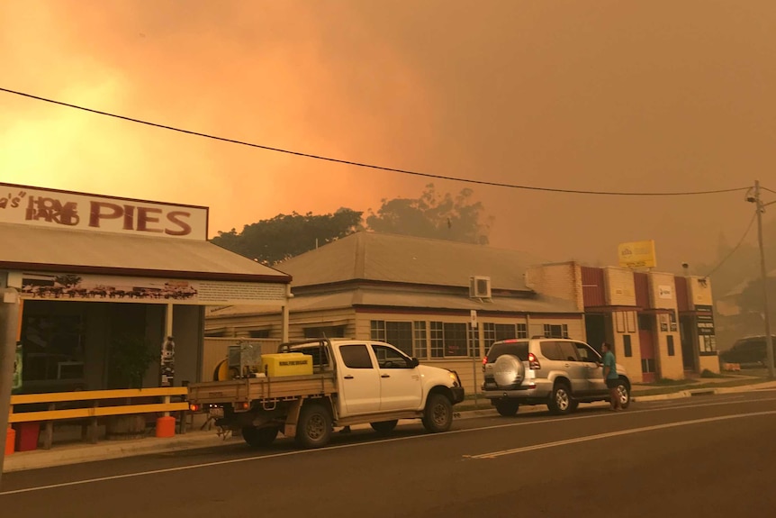 Smoke and ash from a bushfire fill the sky over Mt Larcom's main street