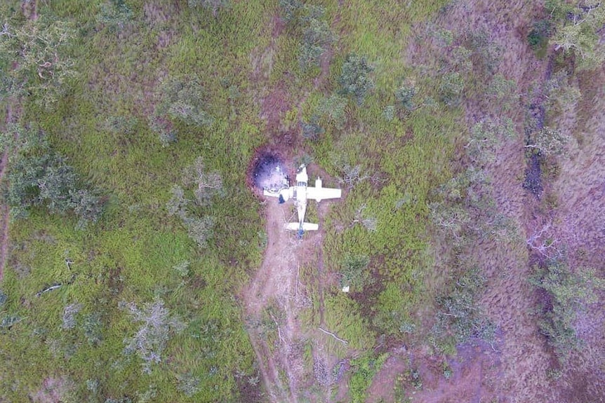 An aerial shot showing a crashed plane at the end of the makeshift runway in PNG.