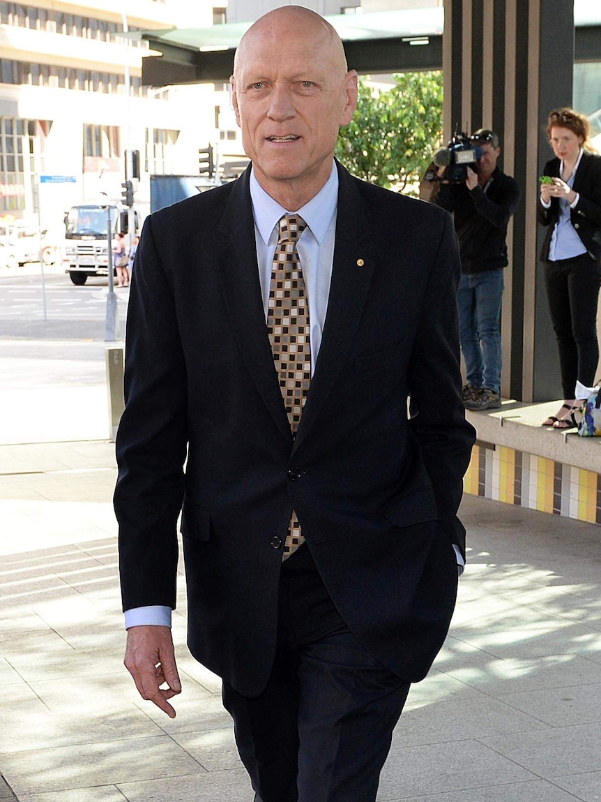 Former Federal Environment minister Peter Garrett arrives at the Magistrates Court in Brisbane.