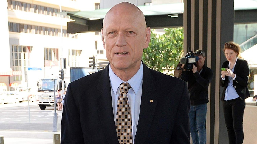 Former Federal Environment minister Peter Garrett arrives at the Magistrates Court in Brisbane.
