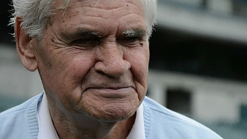 A headshot of an elderly Graham Farmer in a light blue jumper.