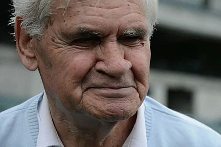 A headshot of an elderly Graham Farmer in a light blue jumper.