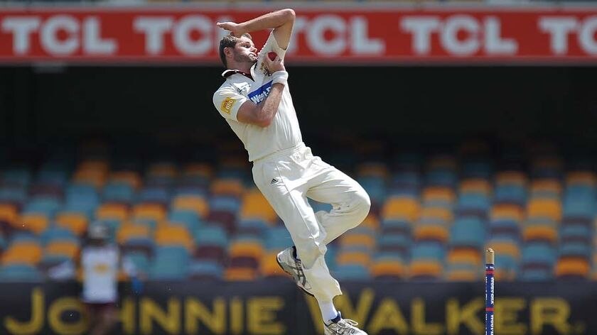 Chris Swan bowls during Western Australia's innings at the Gabba.
