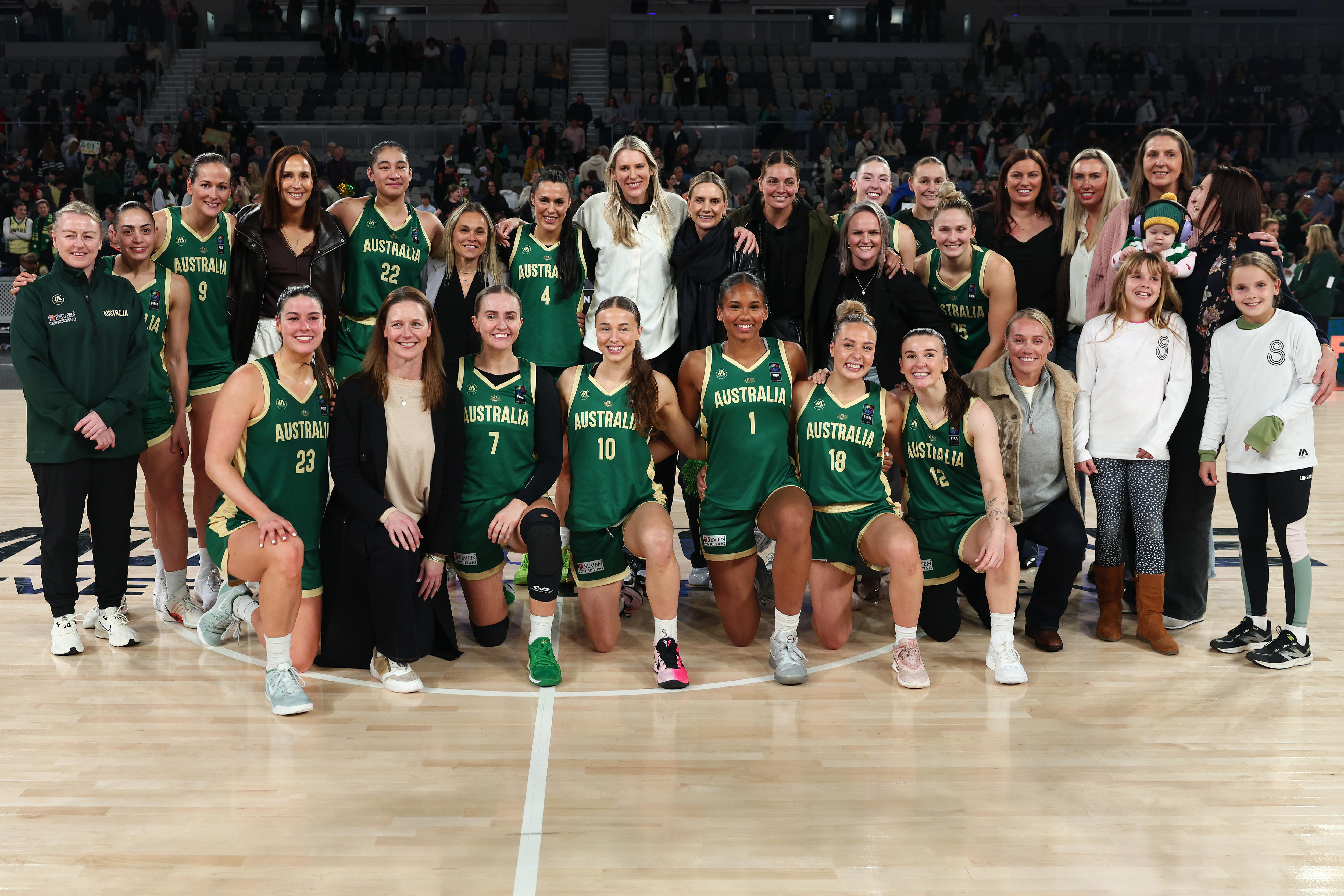 Members of the Opals 2006 squad and current squad pose for a team photo on the court