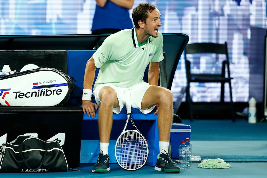 A Russian male tennis player yells at the chair umpire at the Australian Open.
