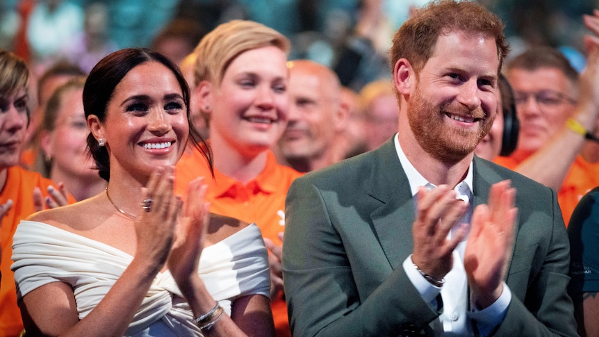Meghan and Harry applauding 