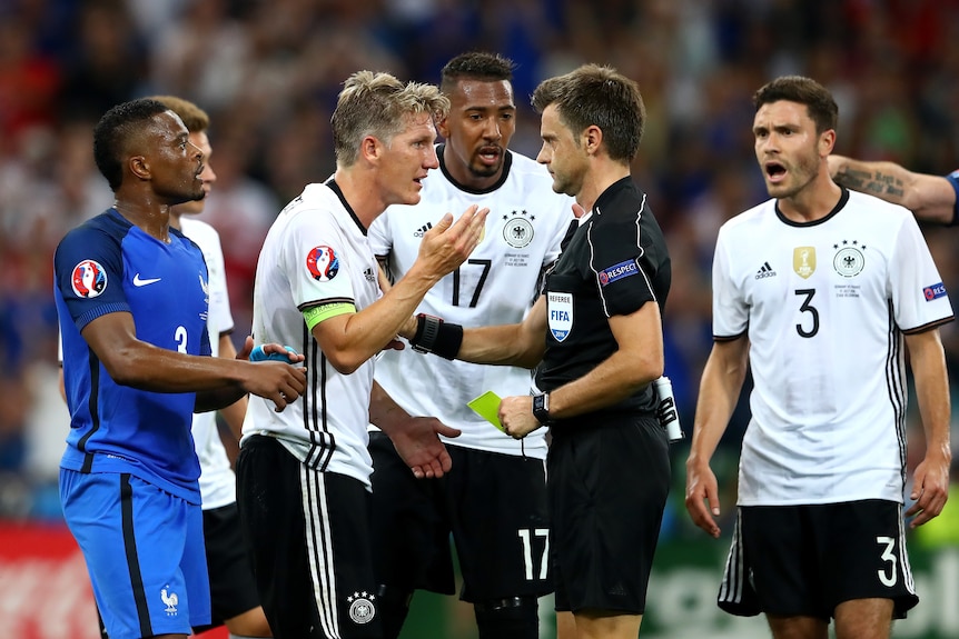 Bastian Schweinsteiger remonstrates with the referee