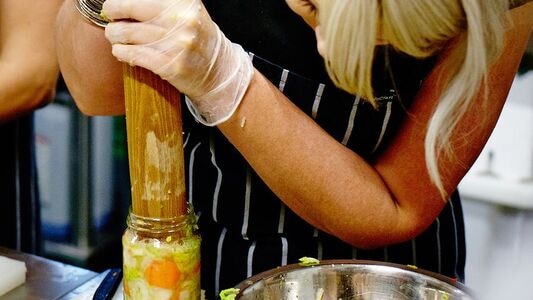 At a fermenting class in Sydney, participants learn to ferment and pickle discarded ingredients to minimise food waste.