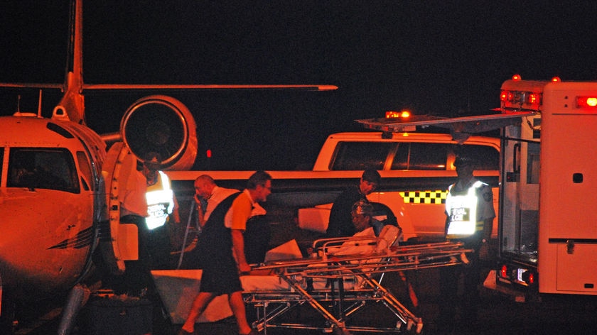 An asylum seeker injured in the explosion arrives in Darwin overnight.