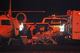 An asylum seeker injured in the explosion arrives in Darwin overnight.