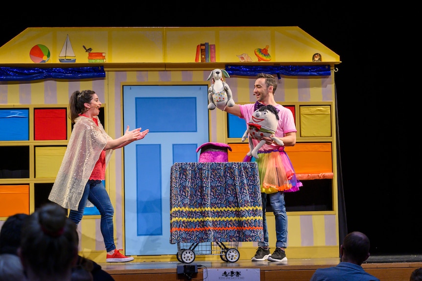 Play school presenters Matt and Emma performing a live show on stage in dress up gear