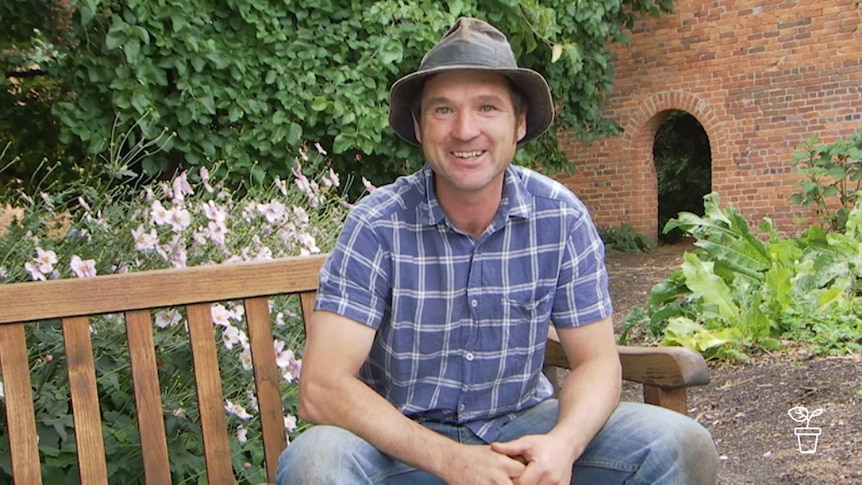 Man sitting on bench seat outdoors