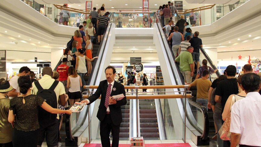 Shoppers on escalators in Brisbane Myer store.