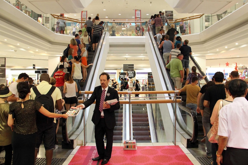 Shoppers on escalators in Brisbane Myer store.