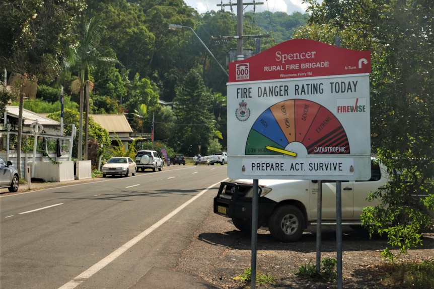 An arrow points to low moderate fire danger warning on a sign