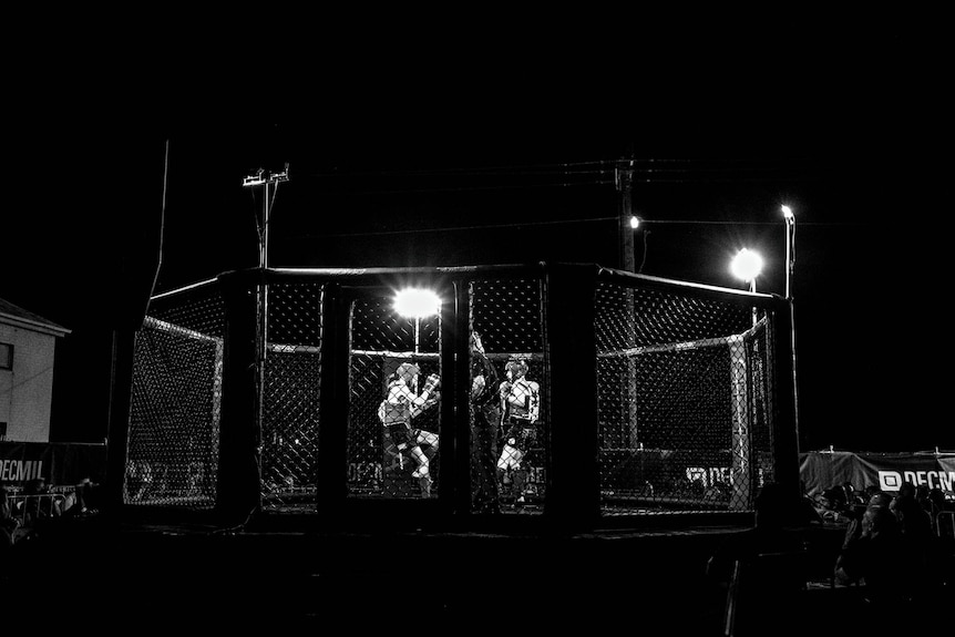 Black and white boxing ring at night