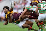 Thaiday off-loads in a tackle