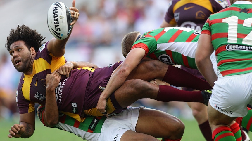 Thaiday off-loads in a tackle
