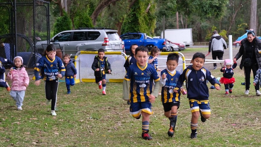 Young children play soccer