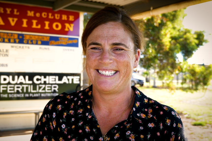 A smiling woman with dark hair.