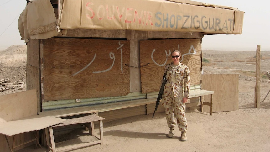 Sally Heidenreich stands in front of an old souvenir shop in Iraq.