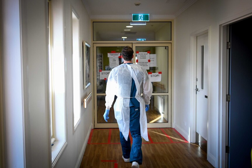 A man walks down a hallway.