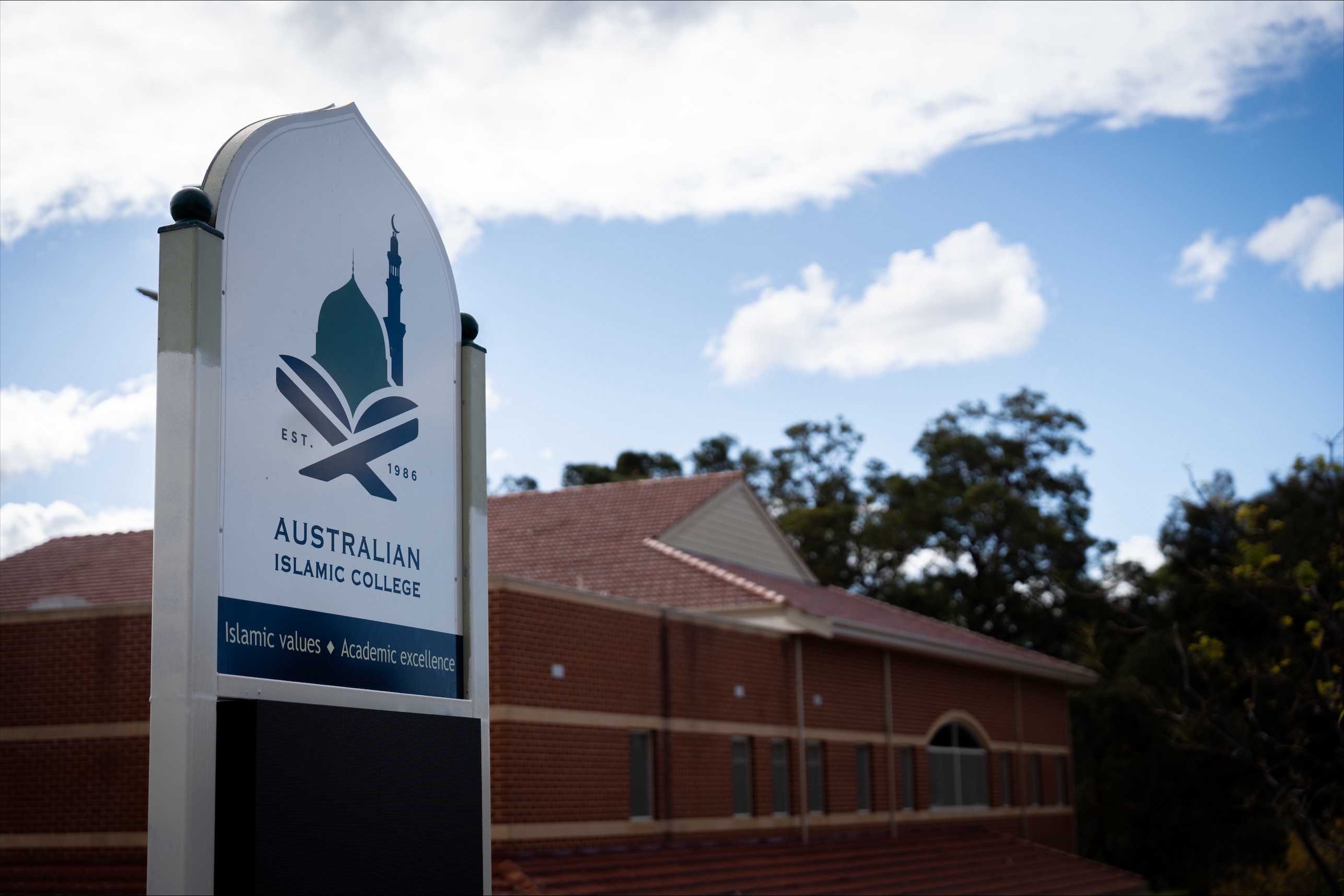 A red brick building with an 'Australian Islamic College' sign in front 