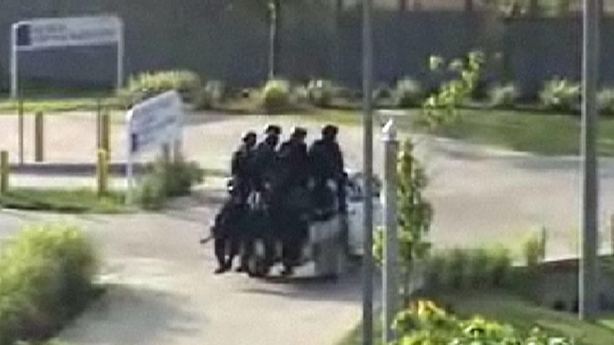 Armoured officers entering the Christmas Island dentention centre, March 2011 (ABC: 7.30)