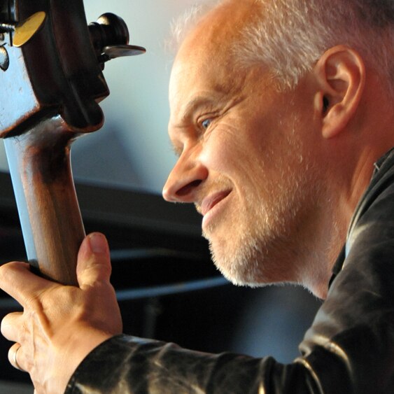 A tight-cropped photo of Lars Danielsson performing on his double bass