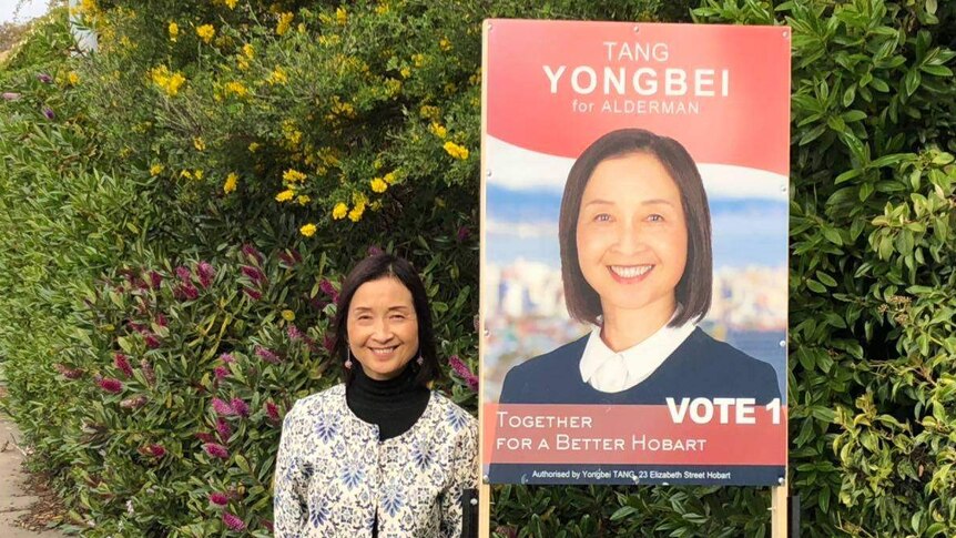 Hobart council candidate Yongbei Tang, with election poster, in a photo from her Facebook page.