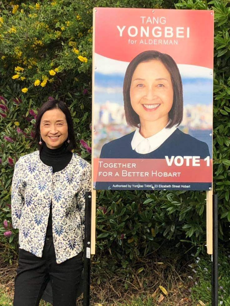 Hobart council candidate Yongbei Tang, with election poster, in a photo from her Facebook page.