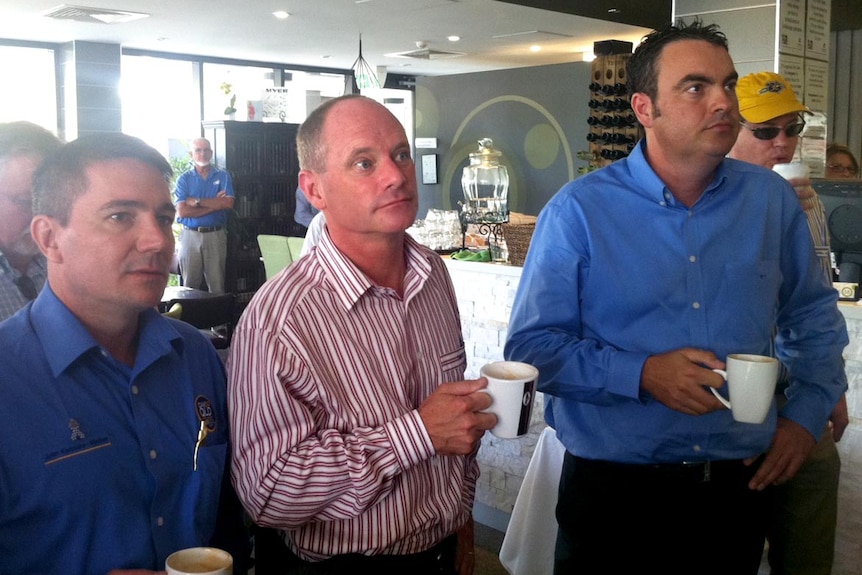 Mr Newman, campaigning in Mackay, watches Prime Minister Julia Gillard speak on TV from Adelaide.
