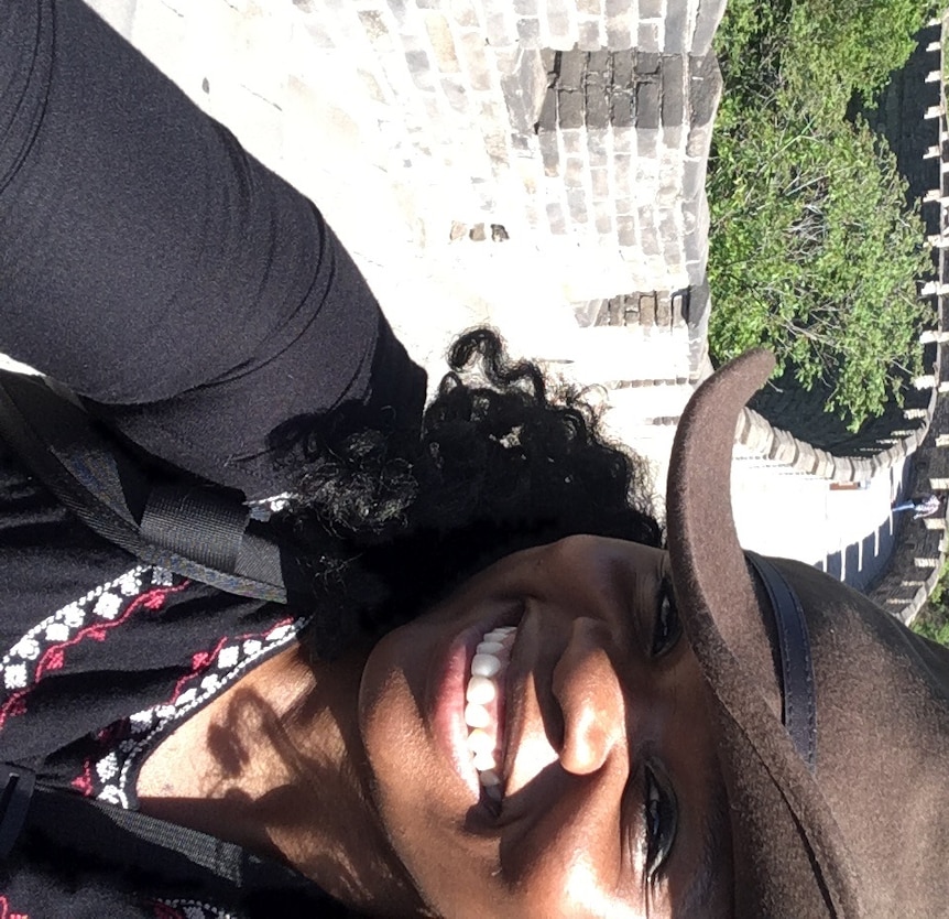 Travel photographer and writer Lola Akinmade Åkerström poses for a selfie on the Great Wall of China