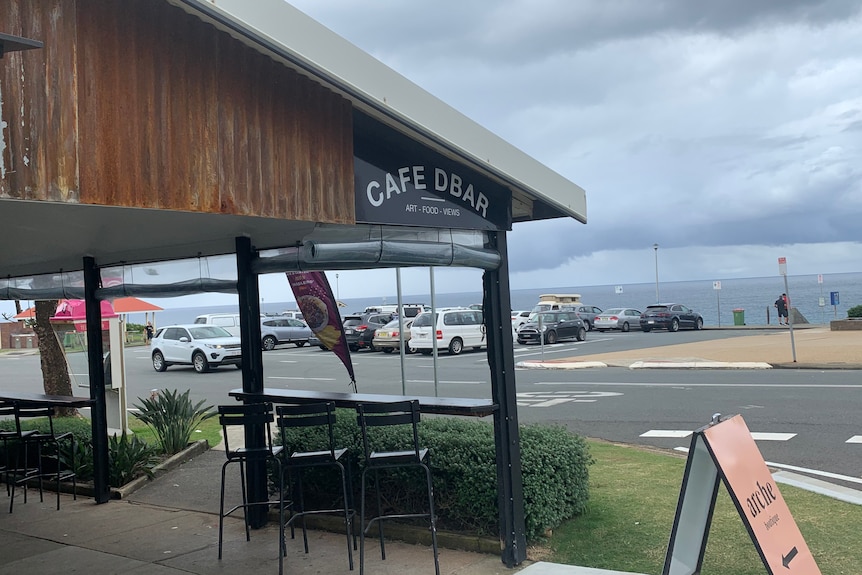 A cafe on a main road with an ocean view.